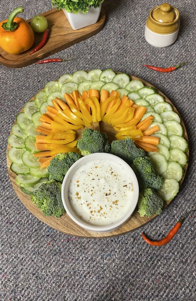 Stunning turkey veggie tray on wooden platter with colorful cucumber slices, carrot sticks, broccoli florets, bell peppers, green beans, and creamy garlic herb dip for healthy party appetizer