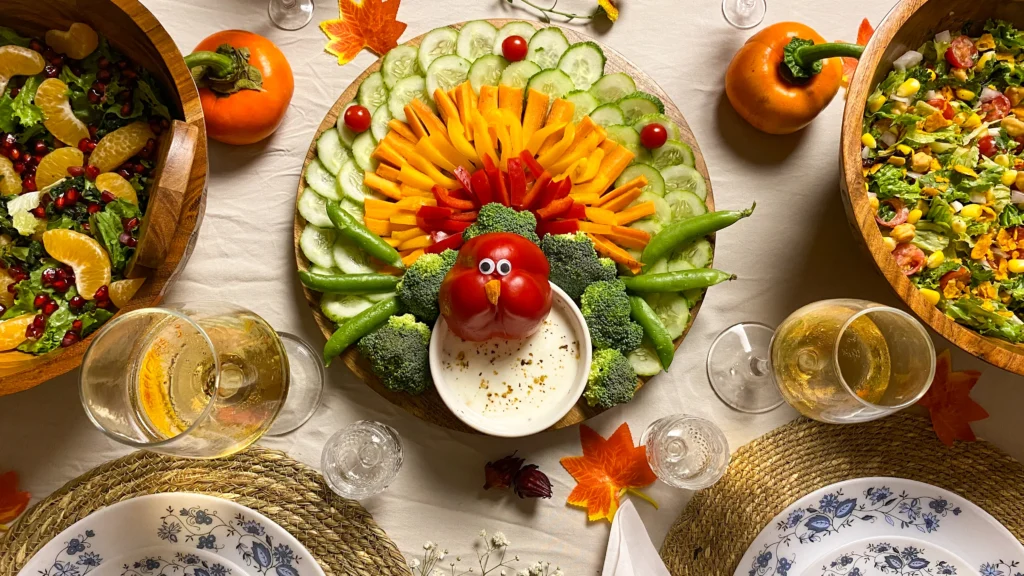 Ultimate Turkey Veggie Tray Thanksgiving appetizer with colorful fresh veggies, festive turkey face made from red bell pepper, creamy herb dip, and wooden serving platter for holiday entertaining